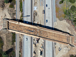 Aerial view of bridge construction crossing the highway, California, USA