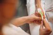 © Strelciuc - Young spa worker applying a cream while preparing the client for the next procedure