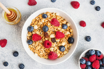 Wall Mural - Healthy breakfast. Fresh granola, muesli with yogurt and berries on grey background. Copy space