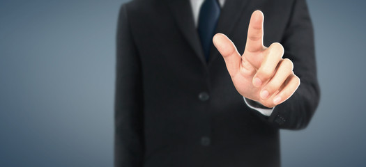 Business portrait of handsome man in black suit.Touch screen