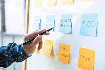 Poster - Young creative business people use post it notes sticky note on board to share idea, Analysis data chart and graph with planning strategy thinking in office