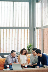 Wall Mural - Group of serious managers meeting at office lounge area to discuss contract details and financial documents