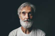 Studio Portrait Of Handsome Senior Man With Gray Beard.