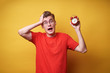 © luengo_ua - Too late! Young shocked man  holding an alarm clock on a yellow background.