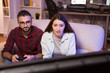 © DC Studio - Joyful young couple playing video games on television