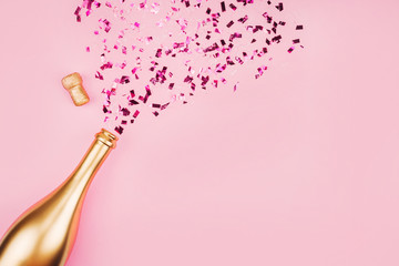 Bottle of champagne and confetti. 