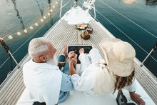 Senior Couple Celebrating Wedding Anniversary On Sailboat - Happy Mature People Having Fun On Boat Trip Vacation - Love Relationship And Travel Elderly People Lifestyle Concept