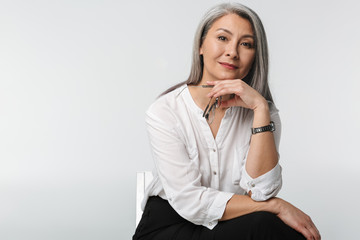 Wall Mural - Image of adult mature woman with long gray hair wearing office clothes