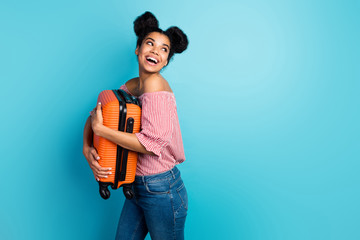 Poster - Profile photo of funny pretty dark skin lady hold big heavy suitcase enjoy traveling look side empty space wear striped red white off-shoulders blouse jeans isolated blue color background