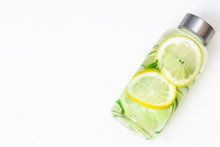 Lemonade With Fresh Lemon. Lemon And Lime Water And Ice In A Glass Bottle. White Background. Copy Space. Concept: Healthy Life, Diet, Sport, Detox. Drink. 