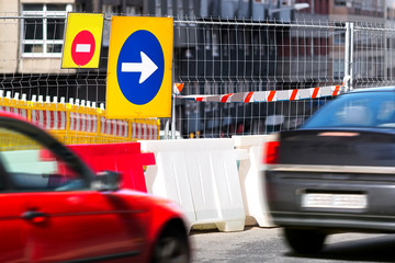 traffic safety roadwork signs and lights on road construction site in city street