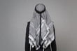 Back rear view of young arabian muslim businessman in keffiyeh kafiya ring igal agal classic black suit isolated on gray wall background studio portrait. Achievement career wealth business concept.
