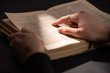 © LIGHTFIELD STUDIOS - Cropped view of woman reading holy bible in dark with sunlight