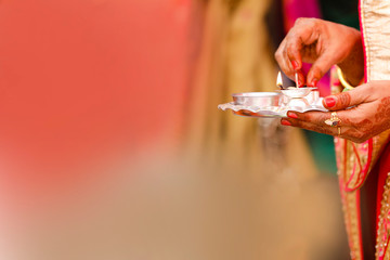 Sticker - Traditional indian wedding ceremony in Hinduism : Holding puja thali and oil lamp in hand