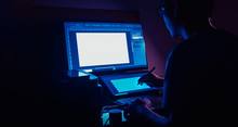freelance designer working at night in his home. with copyspace