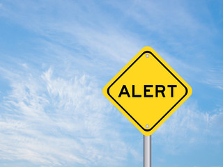 Sticker - Yellow transportation sign with word alert on blue sky background