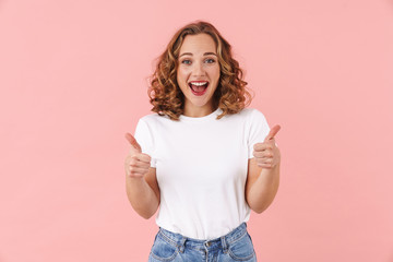 Canvas Print - Pretty woman posing isolated showing thumbs up gesture.