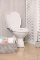 Sticker - White toilet bowl near folding screen in bathroom