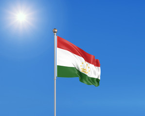 3D illustration. Colored waving flag of Tajikistan on sunny blue sky background.