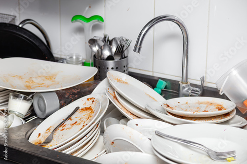 Fotografía Metal sink full of dirty dishes, crockery, tableware