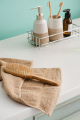 Wall Mural - Hygiene products on shelf with hairbrush on towel in bathroom, zero waste concept