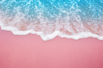 Summer pink sands beach with soft blue ocean wave and beautiful fine sand pink color