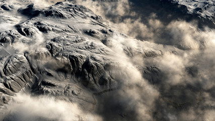 Wall Mural - Rugged rocky terrain in puffy clouds. Digitally generated image.