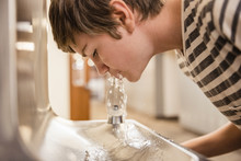 School Kid Drinking From Water Fountain. Red Lodge, Montana, USA