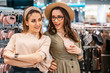 © Natalya Lys - Trade, buyers. Two beautiful girls make purchases in a shopping center, go shopping. LGBT and lesbians. The joy of consumption.