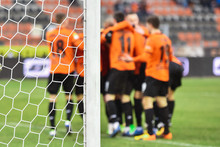 Detail Of Goal's Post With Net And Joy Of Football Team In The Background.