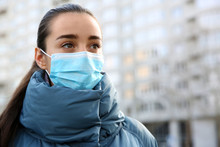 Woman Wearing Disposable Mask Outdoors. Dangerous Virus