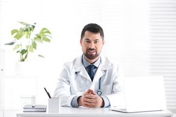 Poster - Portrait of male doctor in white coat at workplace