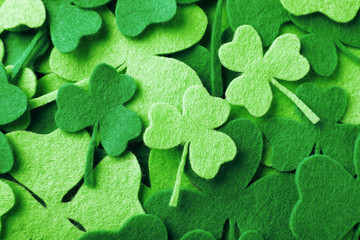 Green clover leaves as background, top view. St. Patrick's Day celebration