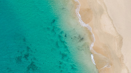  Top View on Coast of Atlantic Ocean, waves on beach aerial view, crystal clear water in Morro Jable Fuerteventura. 