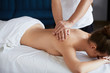 © YURII MASLAK - Young beautiful woman enjoying back and shouders massage in spa.Professional massage therapist is treating a female patient in apartment.Relaxation,beauty,body and face treatment concept.Home massage.
