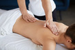 © YURII MASLAK - Young beautiful woman enjoying back and shouders massage in spa.Professional massage therapist is treating a female patient in apartment.Relaxation,beauty,body and face treatment concept.Home massage.