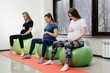 © Andrii - A group of young pregnant mothers are engaged in Pilates and ball sports at a fitness club. Pregnant