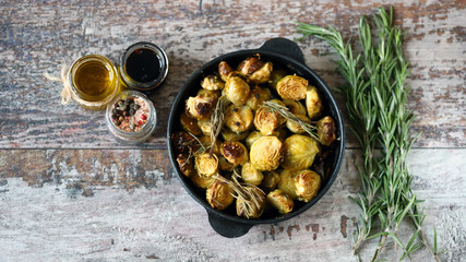 Wall Mural - Baked Brussels sprouts with rosemary and spices. Frying pan with baked brussels sprouts.