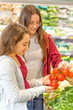 © Natalia - Teen girls shopping in supermarket. Young people make the conscious, organic and healthy choice.