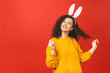 © denis_vermenko - Young caucasian woman wearing cute easter rabbit ears over red isolated background while smiling confident and happy.