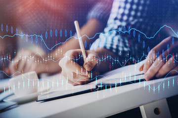 Multi exposure of two men planing investment with stock market forex chart.