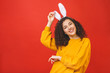 © denis_vermenko - Young caucasian woman wearing cute easter rabbit ears over red isolated background while smiling confident and happy.