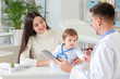 © Pixel-Shot - Woman with little baby visiting pediatrician in clinic
