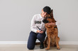 © Pixel-Shot - Female police officer with dog near light wall