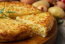 Spanish Omelette With Potatoes And Onion, Typical Spanish Cuisine. Tortilla Espanola. Rustic Dark Background