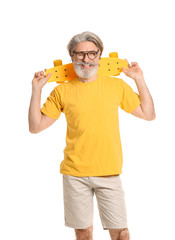 Wall Mural - Stylish elderly man with skateboard on white background