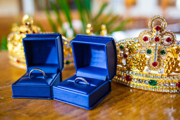 Pair of wedding rings in cases with holy crowns orthodox wedding tradition