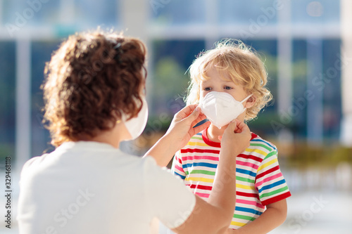 Mother and child with face mask and hand sanitizer