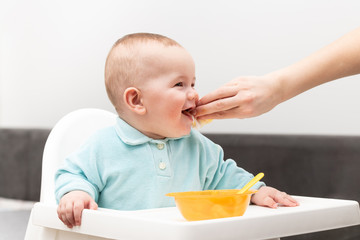 Wall Mural - Mother Cleaning Mouth Of Hungry Baby