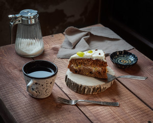 Morning sweet lunch in a rustic kitchen with a slice of cake with tea, served on a wooden table